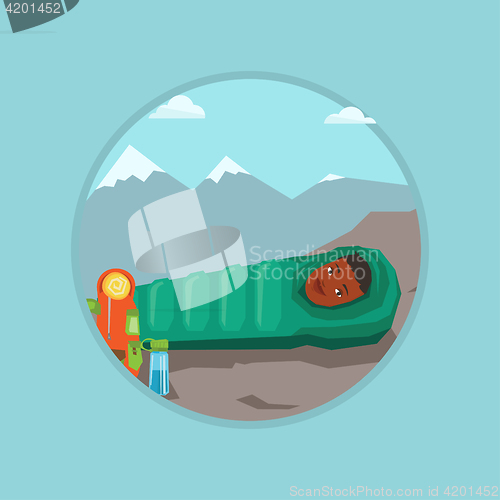 Image of Woman resting in sleeping bag in the mountains.