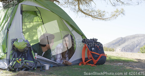 Image of Young couple lying in tent