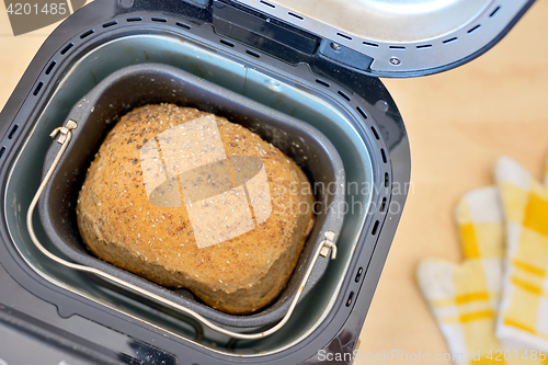 Image of Bread machine  and fresh bread at home
