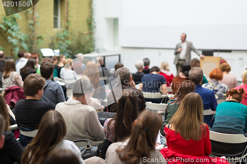 Image of Man giving presentation in lecture hall at university.