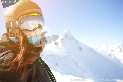 Image of Brunette in helmet among mountains