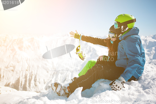 Image of Girl , guy among winter mountain