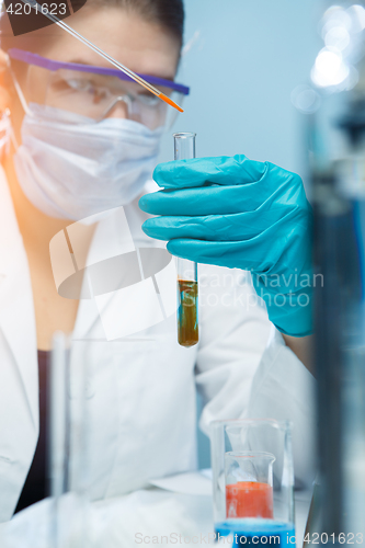 Image of Young scientist handling chemical agents