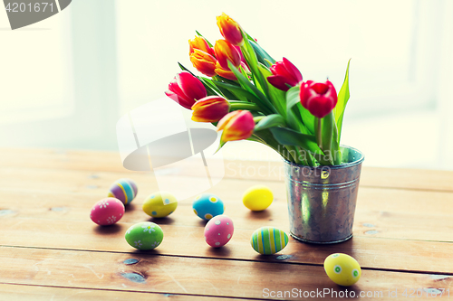 Image of close up of easter eggs and flowers in bucket