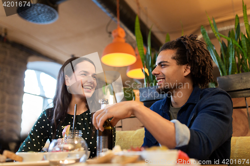 Image of happy couple with drinks at cafe or bar