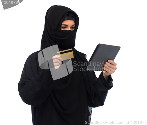 Image of woman in hijab with tablet pc and credit card