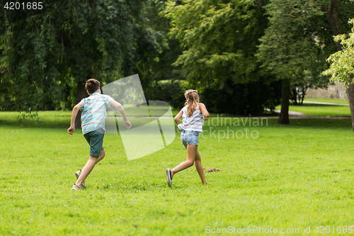 Image of group of happy kids or friends playing outdoors