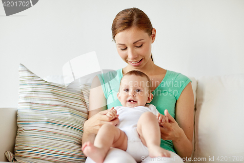 Image of happy young mother with little baby at home