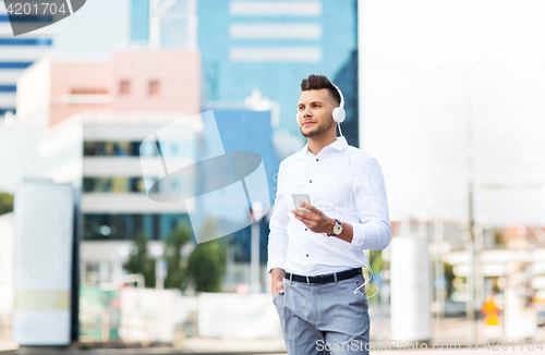 Image of man with headphones and smartphone listening music