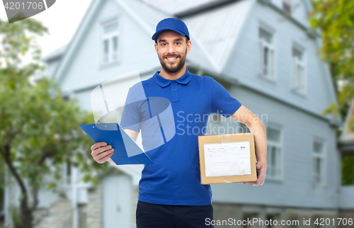 Image of happy delivery man with parcel box and clipboard