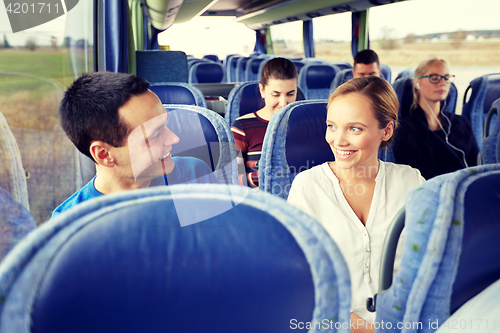 Image of group of happy passengers in travel bus