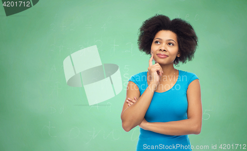 Image of pensive afro american  woman over green chalkboard