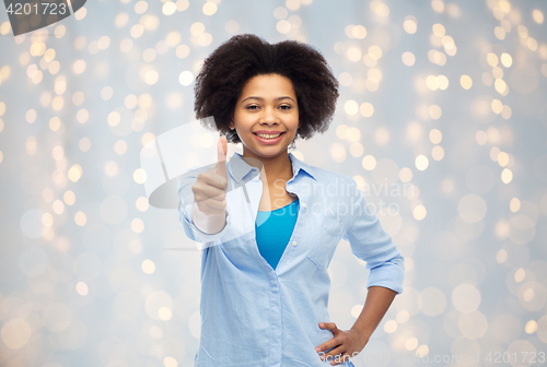 Image of happy african american woman showing thumbs up