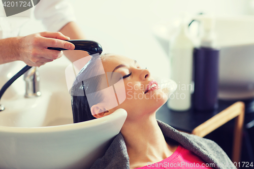 Image of happy young woman at hair salon