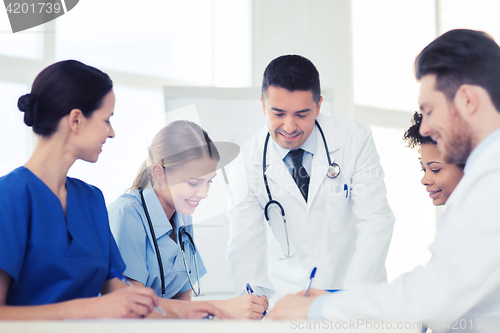 Image of group of happy doctors meeting at hospital office