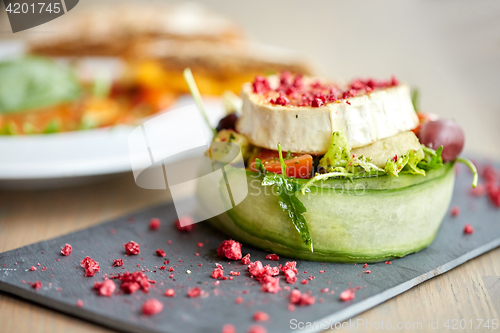 Image of goat cheese salad with vegetables at restaurant