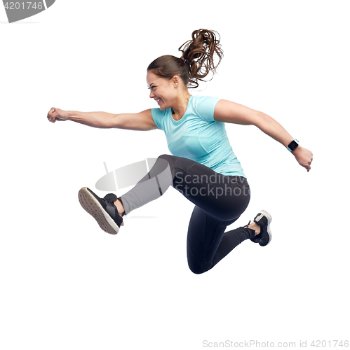 Image of happy smiling sporty young woman jumping in air