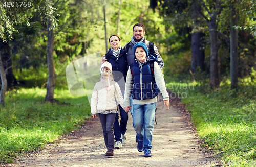 Image of happy family with backpacks hiking