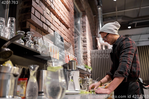 Image of man or barman cooking smoothie at vegan cafe