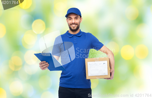 Image of happy delivery man with parcel box and clipboard