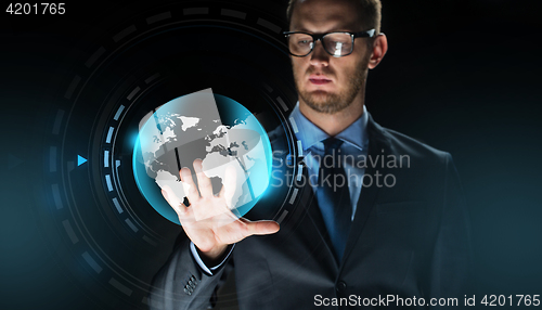 Image of businessman with virtual earth globe projection