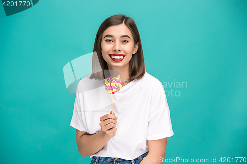 Image of The young woman with colorful lollipop