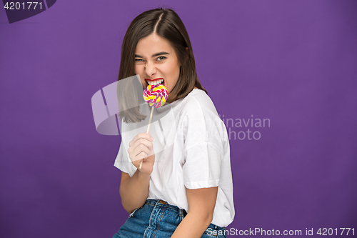 Image of The young woman with colorful lollipop