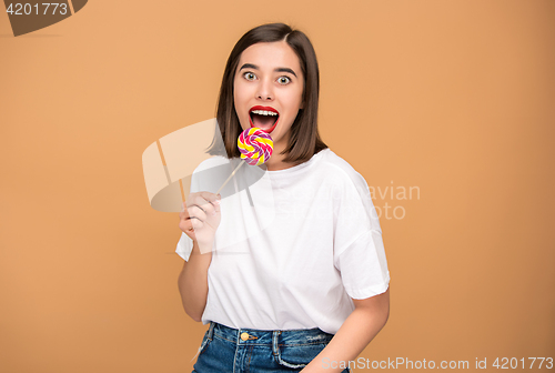 Image of The young woman with colorful lollipop