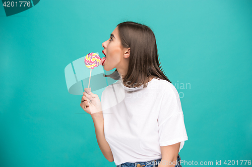 Image of The young woman with colorful lollipop