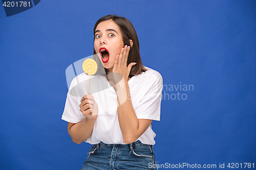 Image of The young woman with colorful lollipop