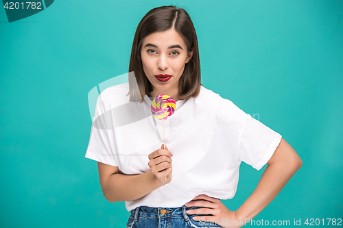 Image of The young woman with colorful lollipop