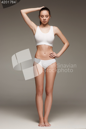 Image of Young, slim, healthy and beautiful woman in white lingerie