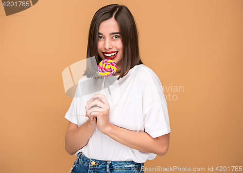 Image of The young woman with colorful lollipop