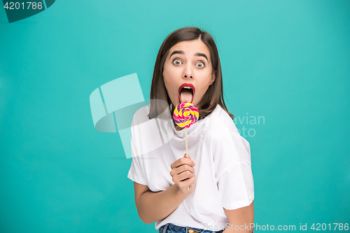 Image of The young woman with colorful lollipop