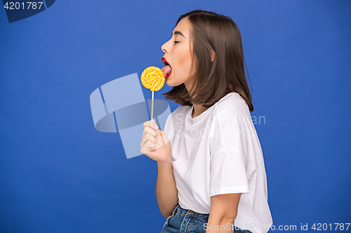 Image of The young woman with colorful lollipop