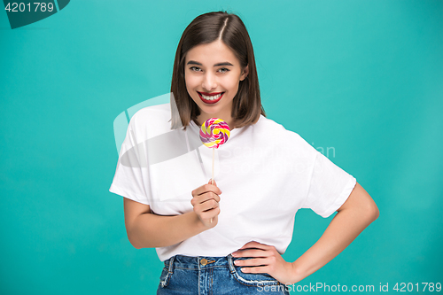 Image of The young woman with colorful lollipop