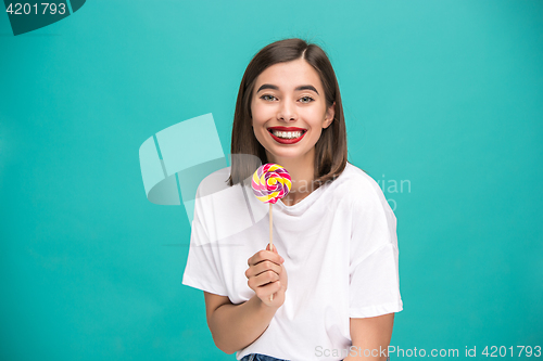 Image of The young woman with colorful lollipop