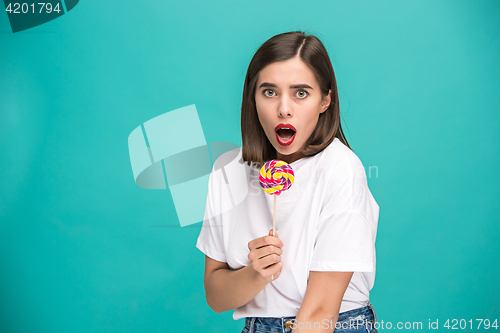 Image of The young woman with colorful lollipop