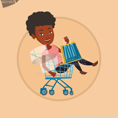 Image of Happy woman riding by shopping trolley.