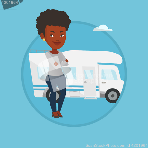 Image of Woman standing in front of motor home.