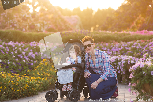 Image of mother and daughter in flower garden