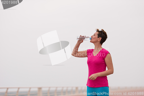 Image of Fitness woman drinking water