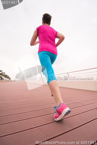 Image of woman busy running on the promenade