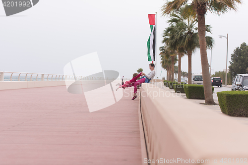 Image of mother and cute little girl on the promenade by the sea