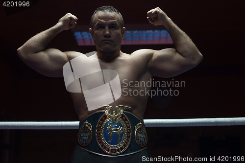 Image of kick boxer with his championship belt