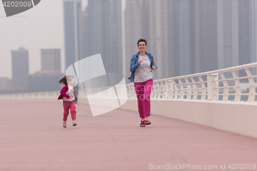 Image of mother and cute little girl on the promenade