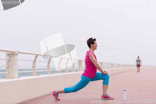 Image of woman stretching and warming up on the promenade