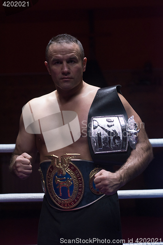 Image of kick boxer with his championship belt