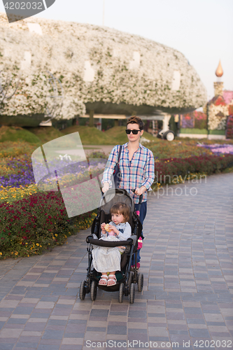 Image of mother and daughter in flower garden