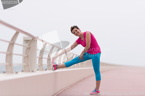 Image of woman stretching and warming up on the promenade